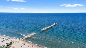 A pier extending into the sea with a beach area at the end. - Beachside Bliss • Renovated Studio • Walk to Ocean & Restaurants + Saltwater Pool (Fort Lauderdale)