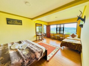 A hotel room with two beds, a dining area, and a view of the mountains. - House of Leisure Holiday Bungalow  (Nuwara Eliya)