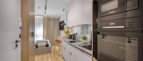 Una cocina moderna con microondas Bosch, horno y cafetera.