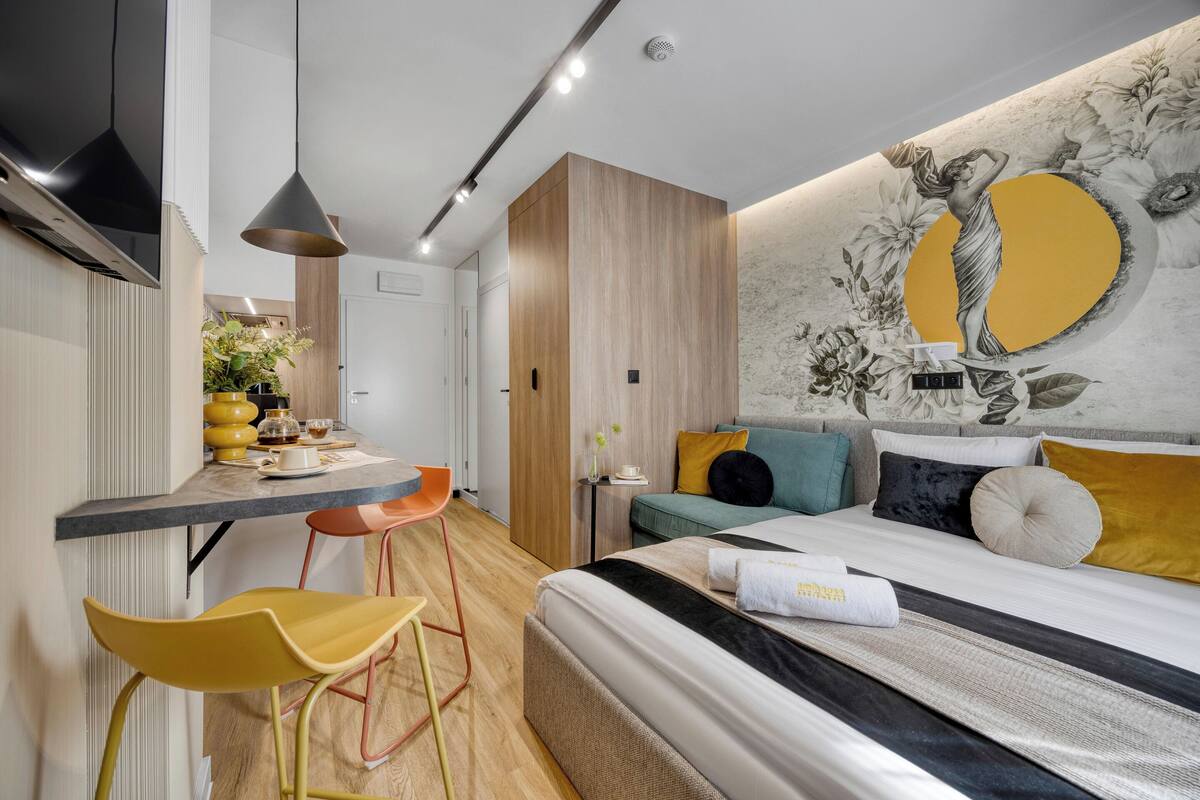 A modern bedroom with a bed, a desk, and a chair.