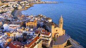 A coastal town with a prominent church and a sea view. - Superior guest room with private bathroom (Sitges)