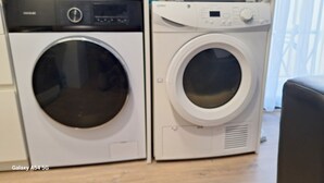 Two front-loading washing machines in a laundry room. - Superior guest room with private bathroom (Sitges)