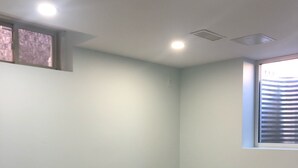 A room with light blue walls, a window with blinds, a recessed ceiling light, and a wooden floor. - Modern Luxury Private Suite | 1+Den • 1.5 Bath • Parking (Mississauga)