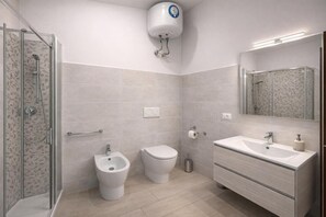 A modern bathroom with a glass shower enclosure, a bidet, a toilet, and a vanity with a sink. - Vespucci Studio - Next to the Sea (Alassio)