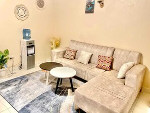 Family Apartment, City View | Living area | 32-inch Smart TV with digital channels