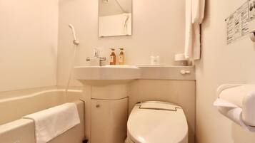 A bathroom with a bathtub, toilet, sink, and mirror.