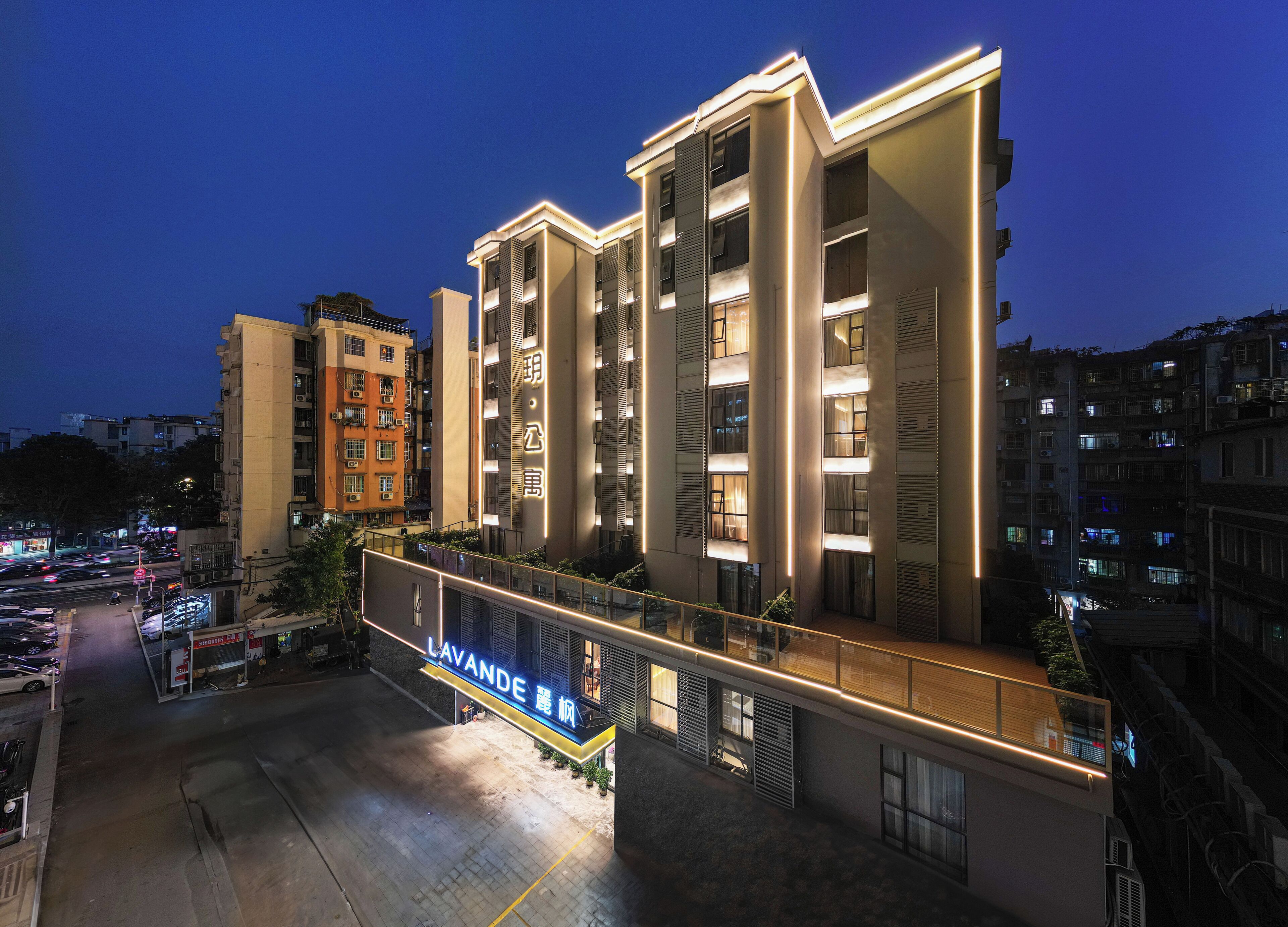A modern building with multiple floors, balconies, and a prominent sign for "LAVANDE".