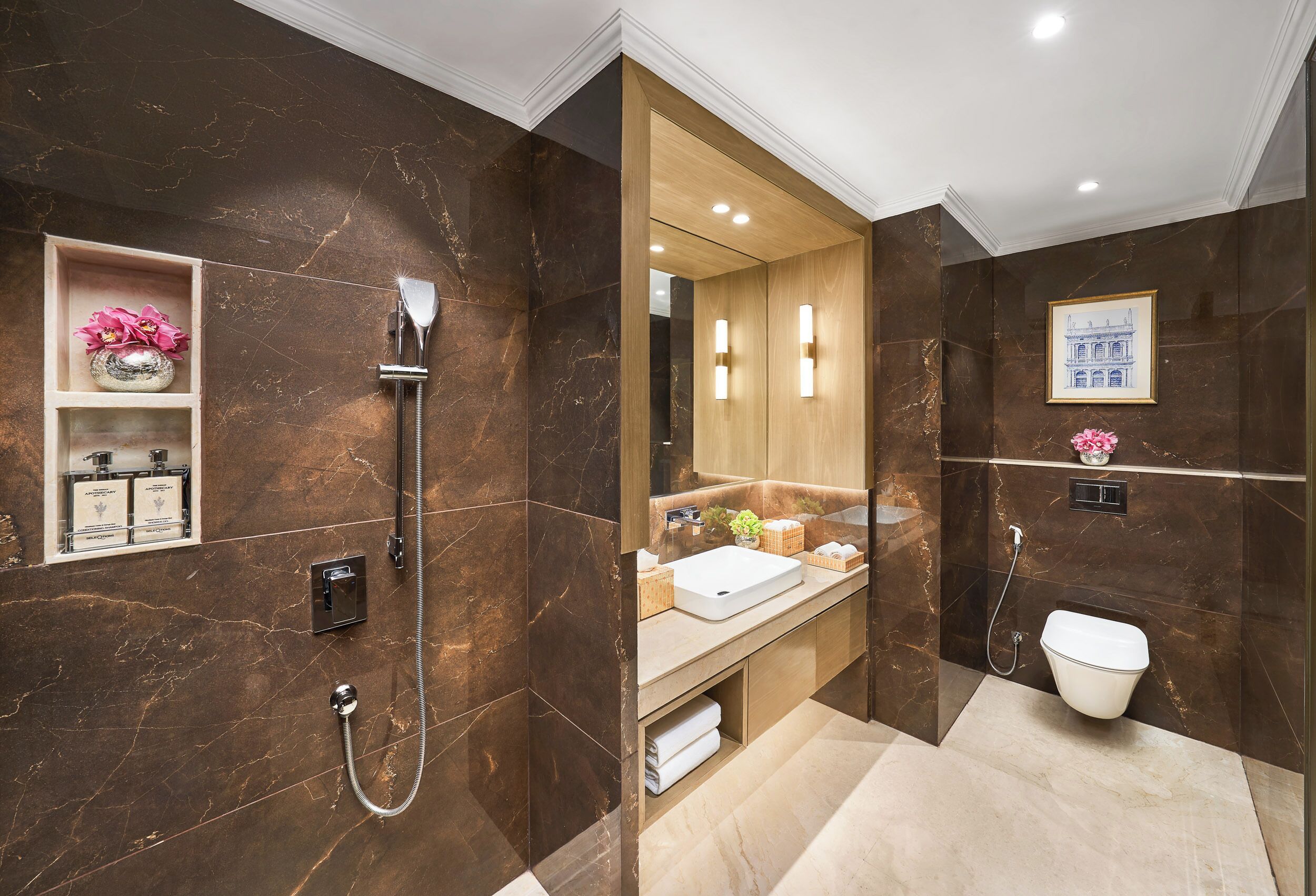 A modern bathroom with a shower, toilet, and vanity.