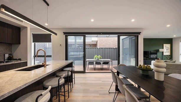 A modern kitchen with a central island, bar stools, and a dining area with a table and chairs. - Rooftop Deck & Sauna, 350m to Safety Beach (Safety Beach)