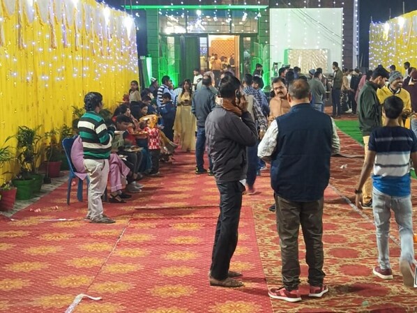 A crowded indoor event with people standing and conversing. - Hotel Swastik Bhumi (Gaya)