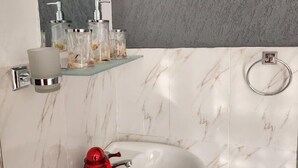 A bathroom with a white sink, a mirror, and a shower. - Maara Lodge Chogoria (Chogoria)