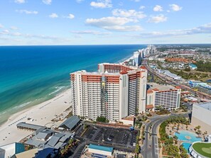 A high-rise hotel with multiple floors, a beach, and a clear view of the ocean. - 2.5b3ba Gulf Front | Pool, Hot Tub | Beach chairs! (Panama City Beach)
