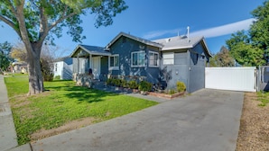A two-story house with a front yard, a driveway, and a white fence. - Family-Friendly Home 2 Mi to Dtwn Riverside (Riverside)