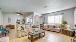 A spacious living room with two sofas, a coffee table, and a ceiling fan. - Family-Friendly Home 2 Mi to Dtwn Riverside (Riverside)