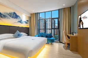 A modern hotel room with a large bed, a desk, a sofa, and a large window offering a city view. - AeroLink Hotel Shenzhen Bao'an Airport (Shenzhen)