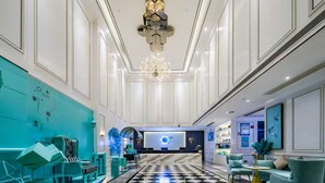 A spacious lobby with a checkered floor, a reception desk, and seating areas. - XANA Lite Hotel International Guangzhou Baiyun Railway Station Sanyuanli Branch - Free Deliver Service to Canton Fair Complex During Canton Fair Period (Guangzhou)