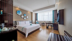A hotel room with a large bed, a desk, a chair, a TV, and a window with curtains. - XANA Lite Hotel International Guangzhou Baiyun Railway Station Sanyuanli Branch - Free Deliver Service to Canton Fair Complex During Canton Fair Period (Guangzhou)