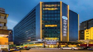 A modern hotel building with a prominent sign for "XANA HOTEL". - XANA Lite Hotel International Guangzhou Baiyun Railway Station Sanyuanli Branch - Free Deliver Service to Canton Fair Complex During Canton Fair Period (Guangzhou)