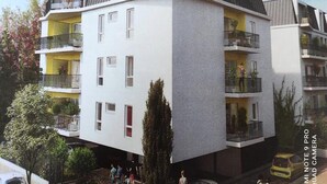 A modern multi-story residential building with balconies, a flat roof, and a visible entrance. - Residence Le Clos Des Merisiers (Aix-les-Bains)