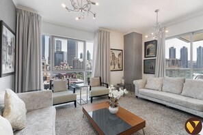 Luxury Apartment, Balcony, City View | Living area | 65-inch Smart TV with cable channels - Vogue| Burj Residence near Dubai Mall Burj Khalifa (Dubai)