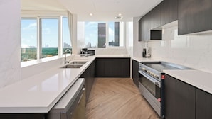 A modern kitchen with a large window, a built-in oven, and a stainless steel sink. - 2501-Bloomfields Luxurious 3BR  West Res (Dubai)