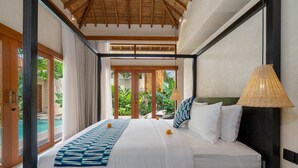 Een ruime slaapkamer met een groot bed, uitzicht op een zwembad en een rieten plafond.