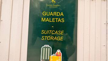 A sign for a luggage storage area at a hotel, indicating where guests can store their suitcases.