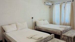 A room with two beds, a bench, and an air conditioning unit. - Borabora Beachfront Malindi Villa  (Malindi)