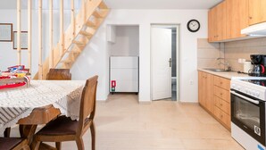 A kitchen with wooden cabinets, a stove, and a sink.