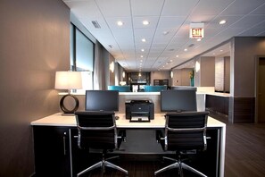 A modern hotel lobby with two desks, a reception area, and an exit sign. - 3 Units | Near Chicago River | Downtown Location (Chicago)