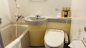 A bathroom with a bathtub, a sink, a toilet, and a mirror. - Kanonji Grand Hotel (Kanonji)