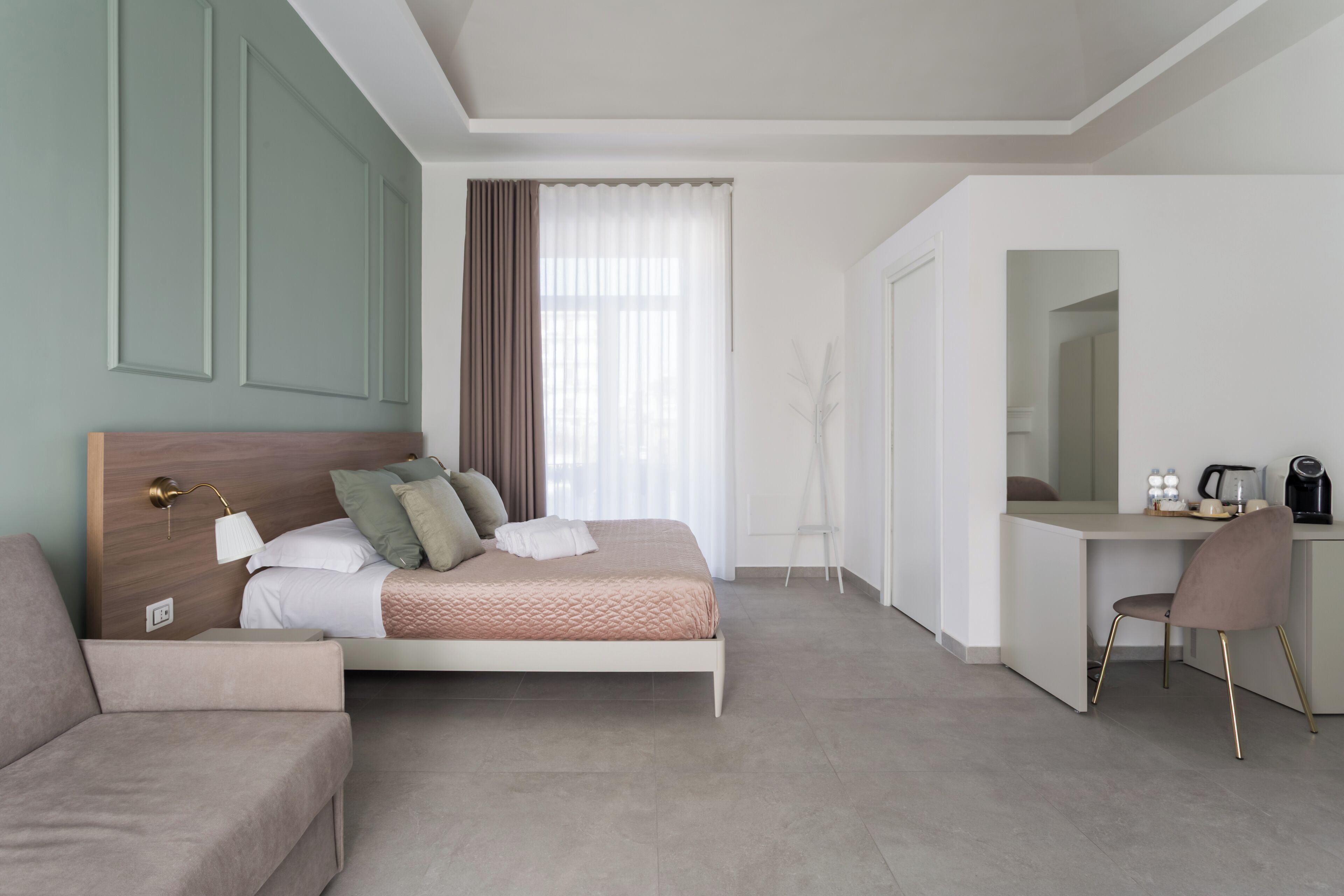 A modern bedroom with a bed, a desk, and a chair.