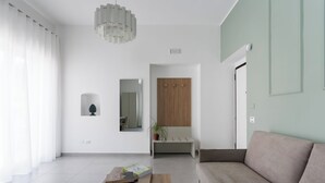 Una sala de estar moderna con un sofá, una mesa de centro, un espejo y un mueble de madera.