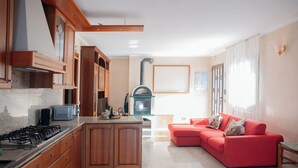 A kitchen with wooden cabinets, a gas stove, a microwave, and a built-in oven.