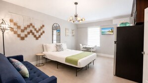 A modern bedroom with a bed, bedside tables, a desk, and a chair. - Miami Studio Gem step from oceans (Miami Beach)