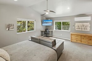A bedroom with a bed, a desk, a chair, and a TV. - Cedar HOT TUB on Front Deck! Resort-Style Backyard w/Sauna, Firepit & Putting Green! PET FRIENDLY! Split Ductless A/C! FREE EV Charger! (Big Bear City)