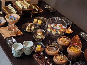 Una mesa de buffet con diferentes alimentos y utensilios para servir.