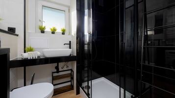 Shower, hair dryer, towels, shampoo
