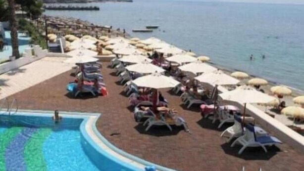 A pool area with lounge chairs and umbrellas, a diving board, and a view of the sea. - Hill Side Suite 1 by PS (Durrës)