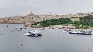 A harbor with multiple boats and a prominent building in the background. - Sliema 3BDR Flat with Seaview and Jacuzzi (Tas-Sliema)