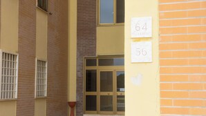 Une entrée d’immeuble avec deux portes visibles, chacune portant un numéro.