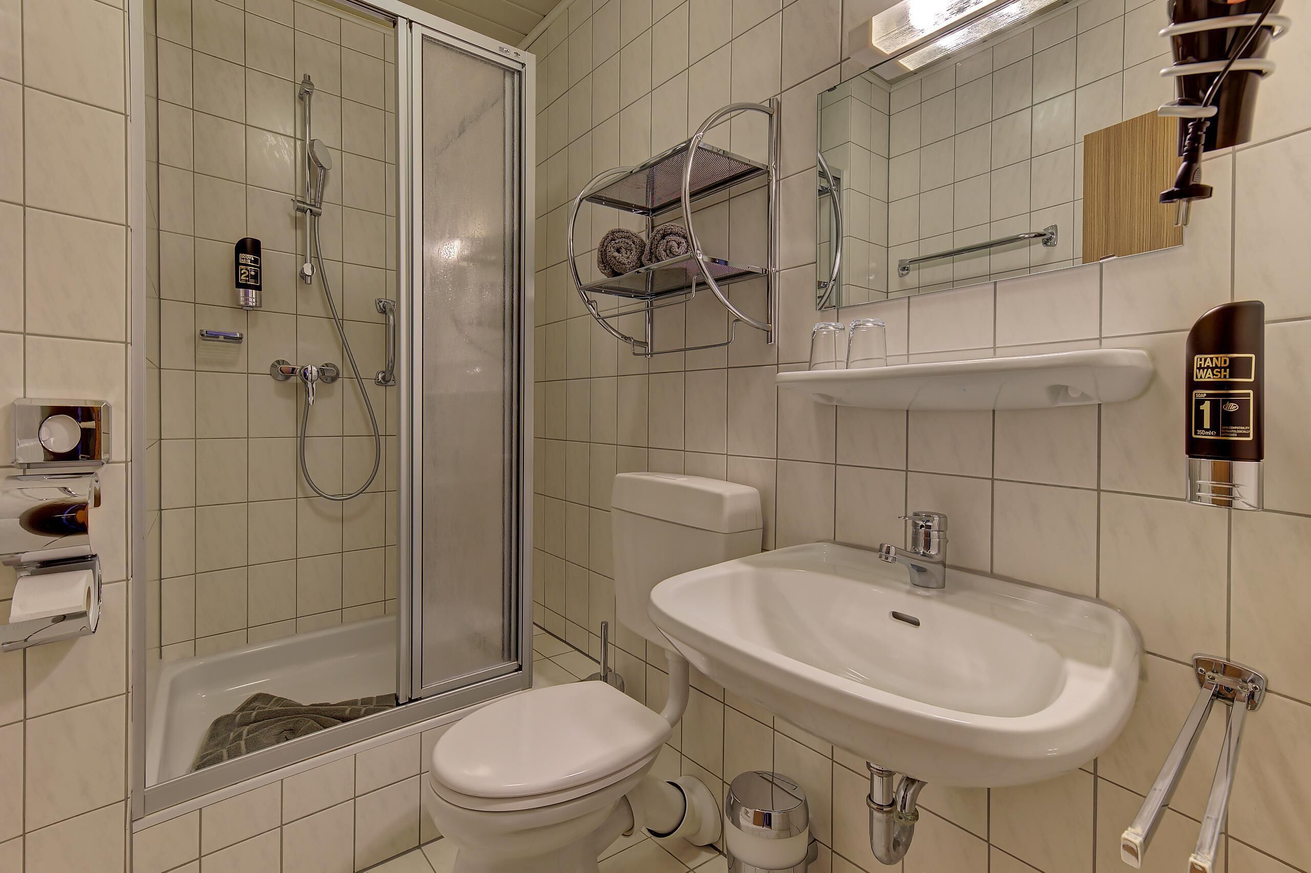 Shower, hair dryer, towels, toilet paper