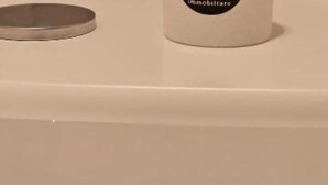 A white cylindrical object with a black label that reads "immobiliare". - Luxury Way Drops of Luxury - Exclusive relaxation with whirlpool in Molfetta (Molfetta)