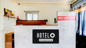 A reception desk with a sign indicating "HOTELO Company-Serviced" and a "RECEPTION" sign above it. - Hotel O Snist University Hyderabad (Hyderabad)