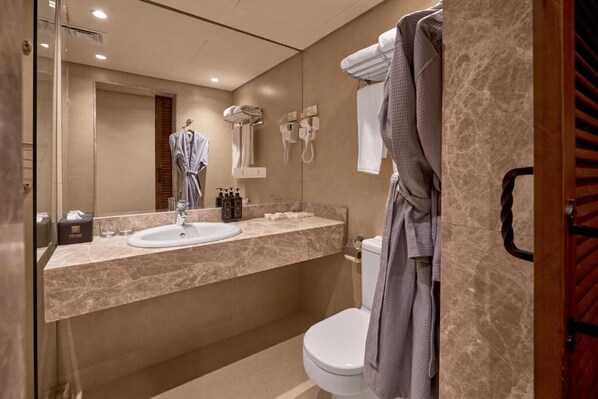 A modern bathroom with a marble countertop, a white sink, a toilet, and a towel rack. - 7 Gates Boutique Hotel Pyramids (Giza)