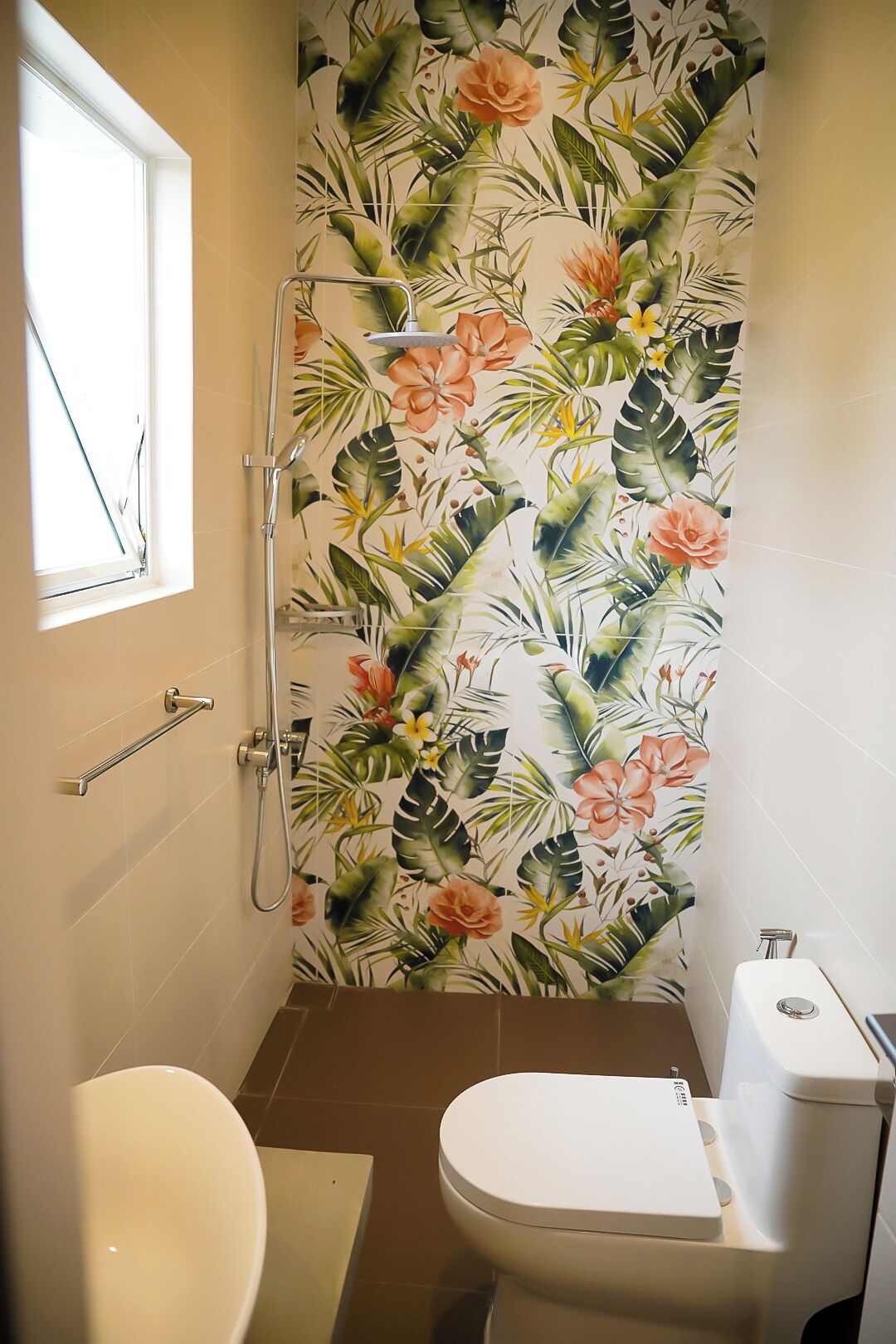 A bathroom with a shower, toilet, and a window.
