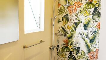 A bathroom with a sink, toilet, and shower.