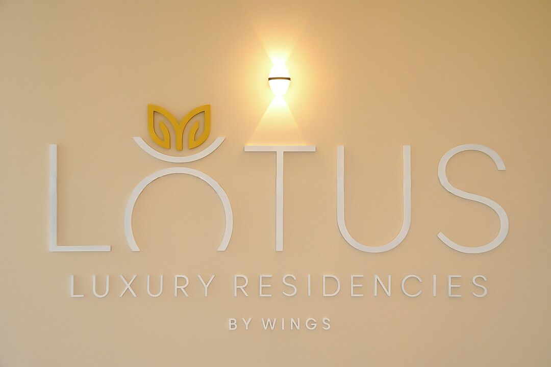 A logo for 'LUTUS Luxury Residencies by Wings' with a stylized lotus flower and a light fixture.