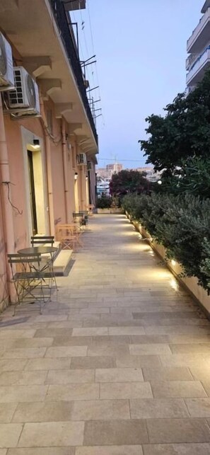 Een verhard pad met terras, airconditioning en een uitzicht op een stadsgezicht.