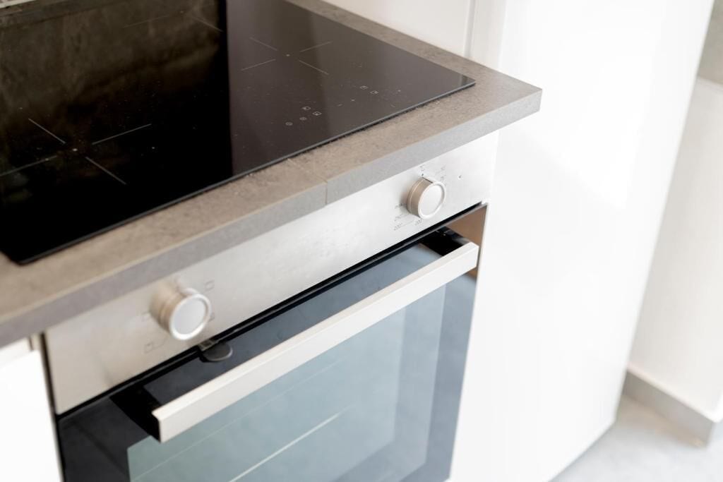 A kitchen with a built-in oven and a stovetop.